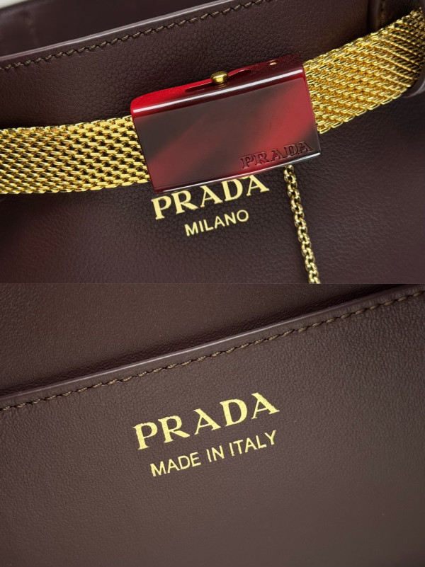 Pra*a buckle leather bucket bag with jeweled belt
